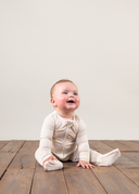 Ribbed Bamboo Baby Sleepsuit in Cream | PLUSH